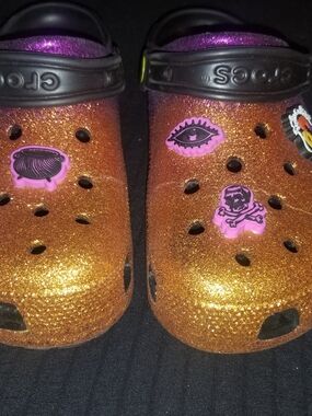 CROCS Kids' Glitter Clog in Orange with Black Strap and Pink Charms